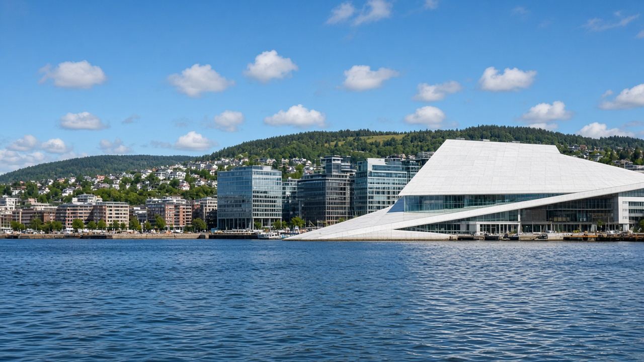 Oslo waterfront with the white opera house roof meeting the fjord
